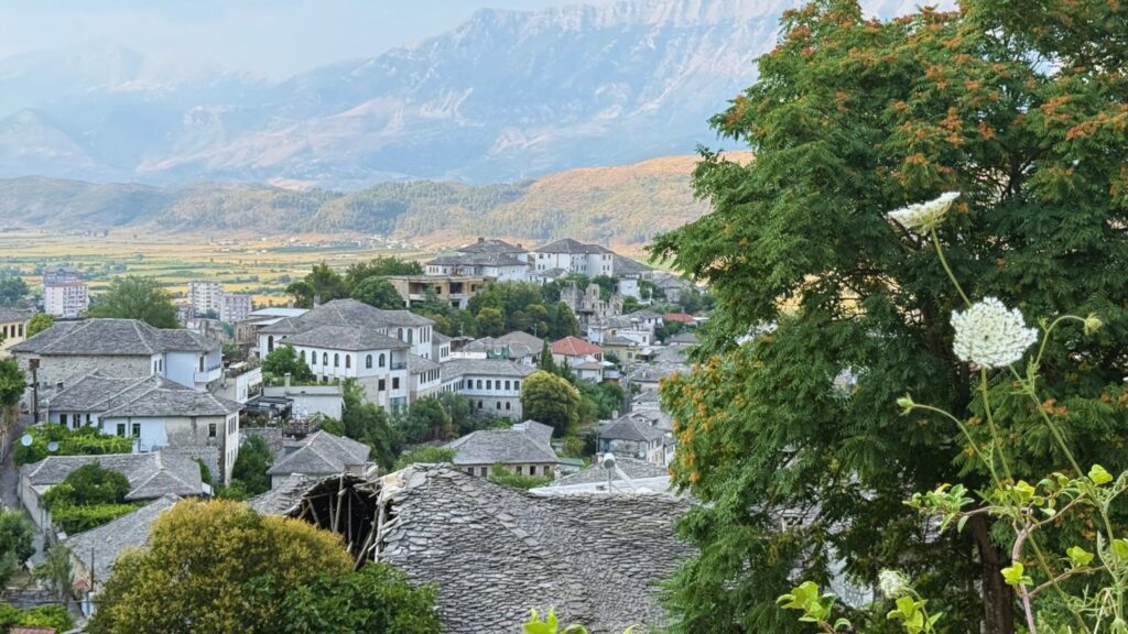Panoramic view of Gjirokastër, Albania with traditional houses and surrounding mountains