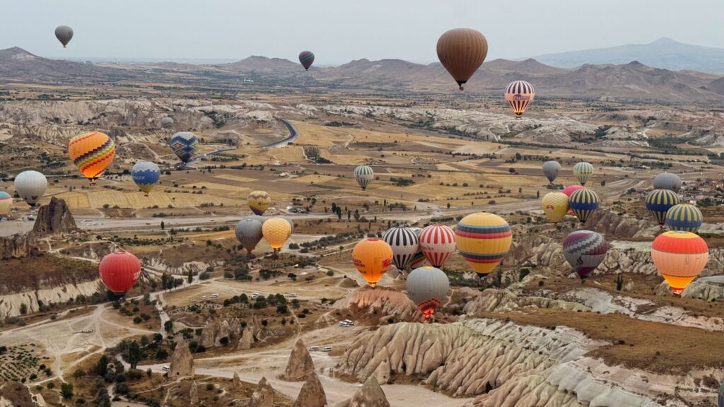 Hot air balloons flying over Cappadocia, Turkey at sunrise