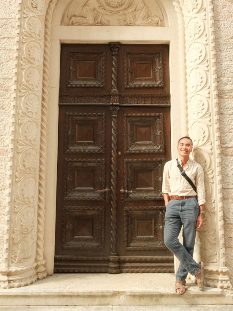 Person standing in front of a door in Old Town Kotor