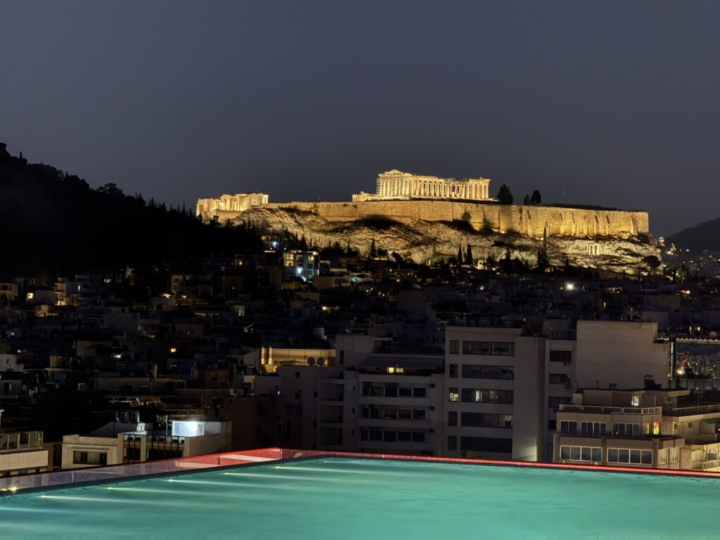 Night view of the illuminated Acropolis and Parthenon from the rooftop infinity pool at the Grand Hyatt Athens, Greece.
