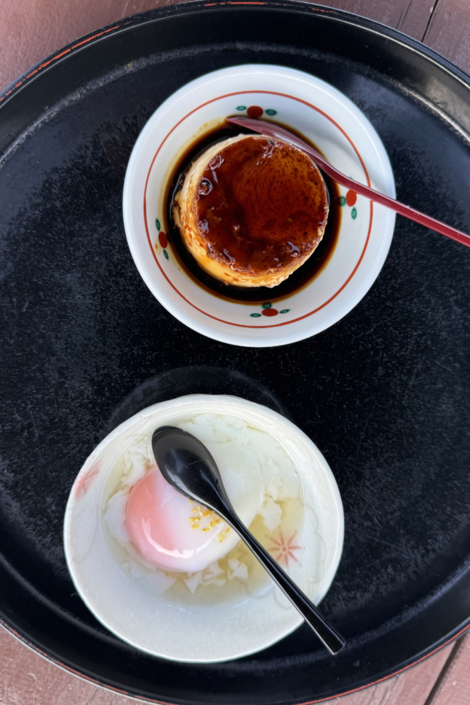 Hell pudding with dark caramel topping served on a black tray in Beppu.