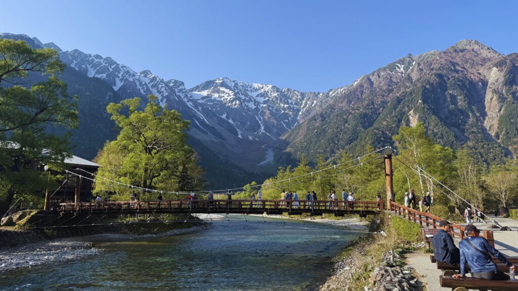 Kappabashi Bridge over the Azusa River in Kamikochi with snow-capped Hotaka mountains behind, the iconic photo on this Japanese Alps itinerary.