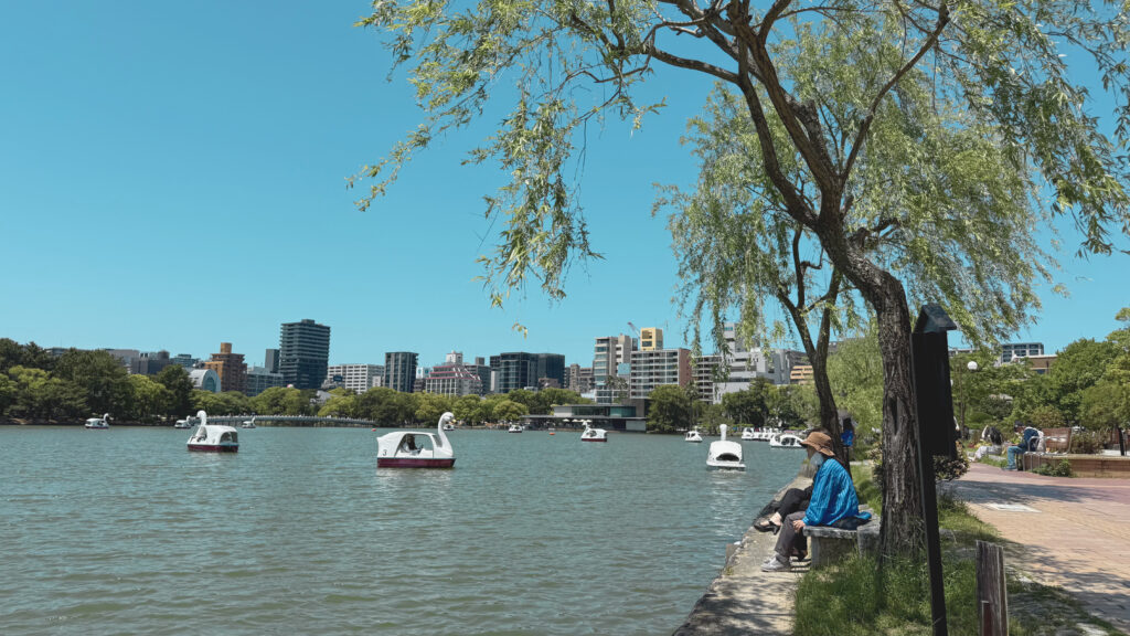 Ohori Lake in Fukuoka with boats and high rises in the background.