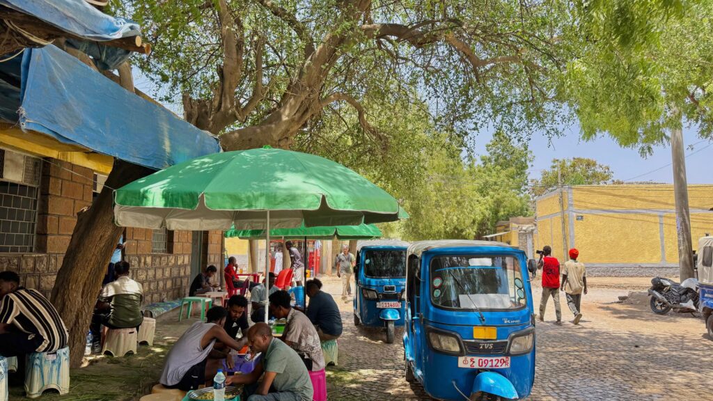Tuk-tuk passing through a street market in Harar, Ethiopia