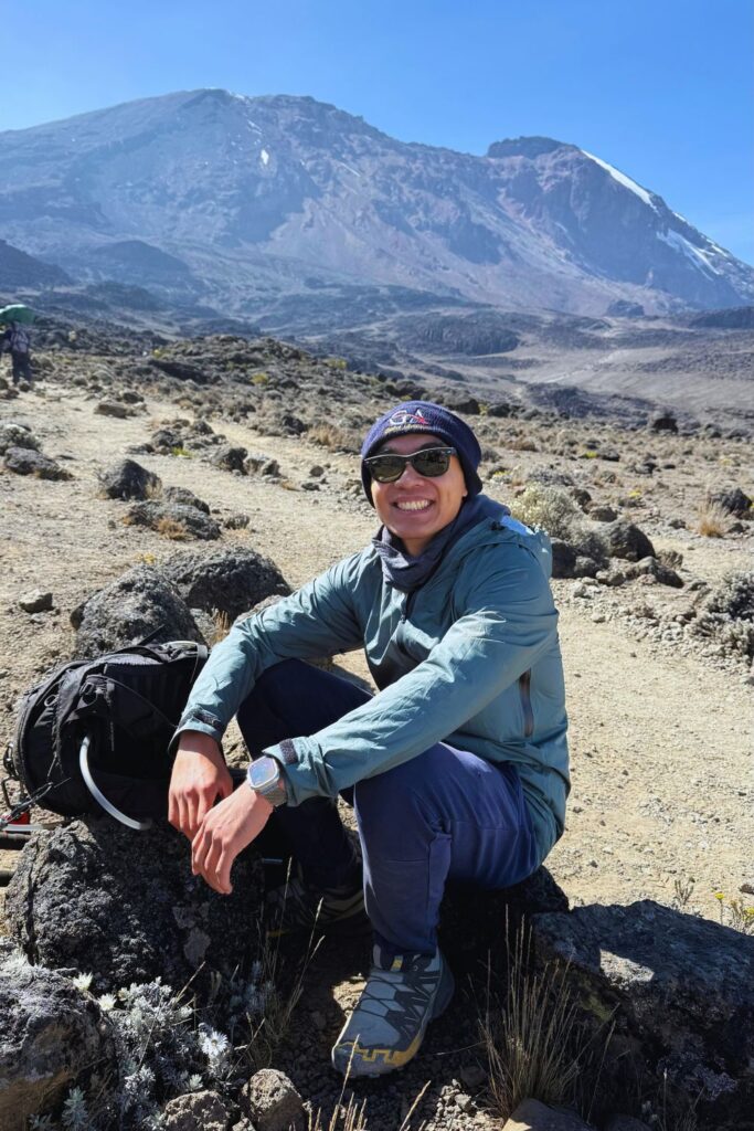 Taking a break on the trail with Kilimanjaro's summit rising in the background