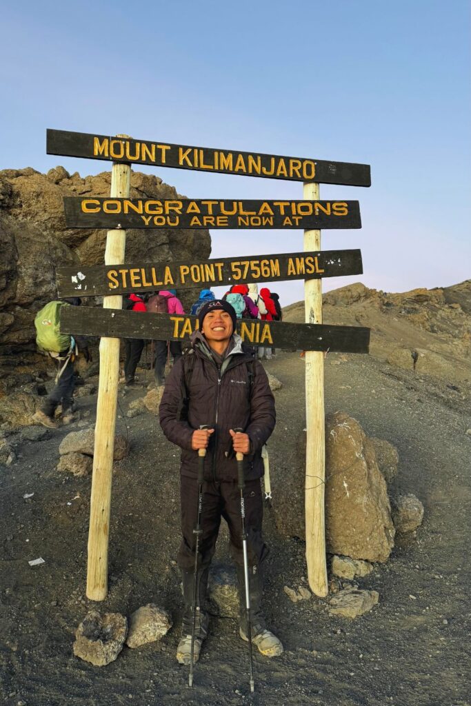 Hiker at the Stella Point sign, 5,756 meters, during the Kilimanjaro summit push