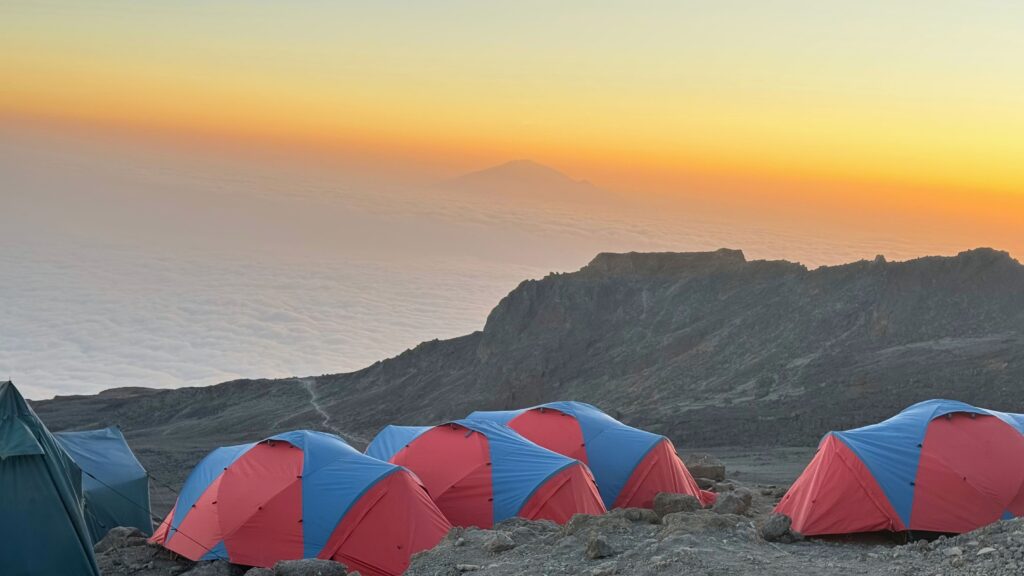 Sunset over a sea of clouds with Mount Meru visible on the horizon from Barafu Camp
