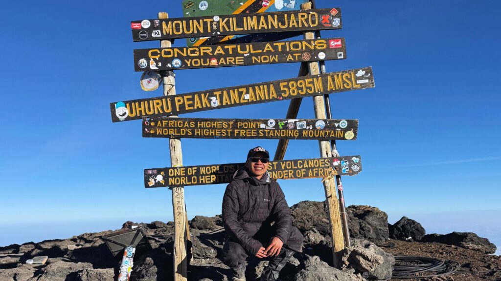 Solo photo at Uhuru Peak, the summit of Mount Kilimanjaro