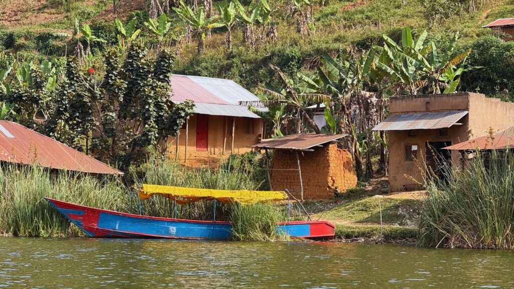 Canoes along the shoreline of a village on Lake Bunyonyi