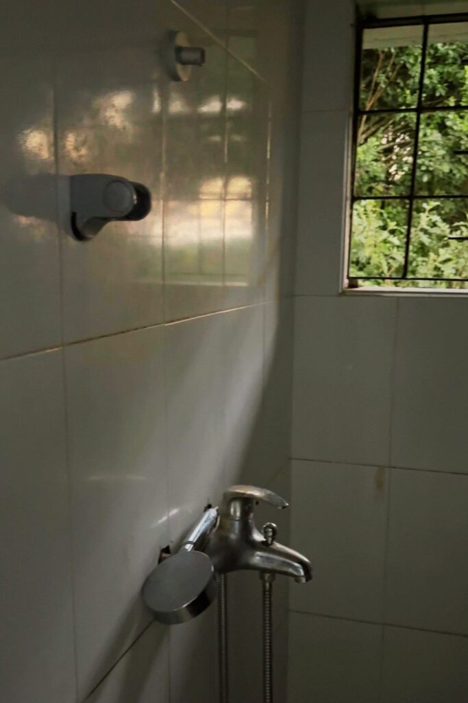 A tiled shared shower and bathroom at a safari campsite